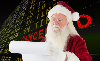 Composite image of santa claus checking his list